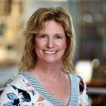 woman with short blonde hair smiling