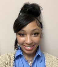 Woman smiling in front of white background