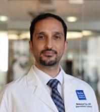 man with dark hair and a goatee