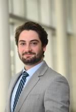 man with brown hair and a beard smiling