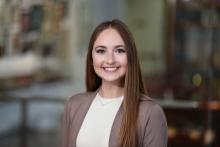 woman with long, light brown hair smiling