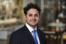 man with dark brown hair smiling