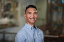 man with short black hair smiling