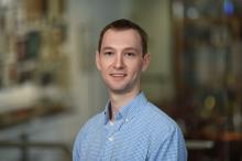man with short, light brown hair smiling