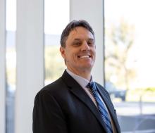 man in a suit smiling