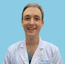 man with short, light brown hair smiling