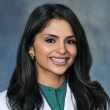woman with long dark hair smiling