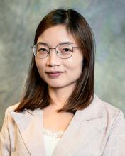 woman with short hair and glasses on smiling