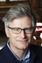 man with glasses on smiling lightly