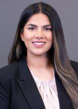 woman with long dark hair and light highlights smiling