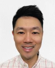 man with short dark hair smiling