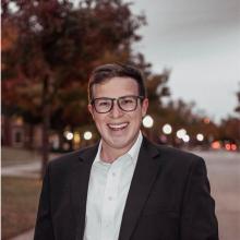 man in a suit smiling