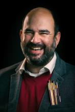 man in a suit with a big smile