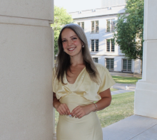 woman in pale yellow dress smiling