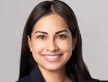 Female with dark hair, wearing dark blazer