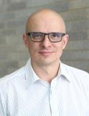 man with glasses on smiling