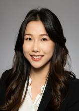 Female smiling with dark hair, wearing black blazer