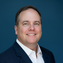 man with a suit on smiling