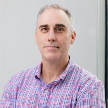 man in a plaid shirt smiling