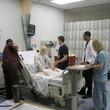 Students from different programs working together to manage a crisis for a simulated patient.