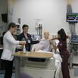 Students from different programs working together to manage a crisis in a simulated patient.
