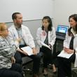 Students from different programs discussing their shared work in communicating a medical error to a standardized patient.