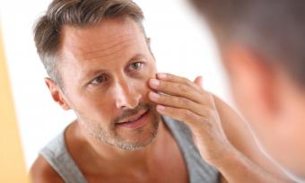 Man looking at face