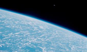 Photo of moon rise over the Earth taken from the Space Shuttle Discovery