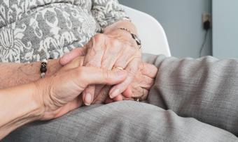 elderly family member holding hands