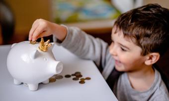 A child saving money in a piggy bank