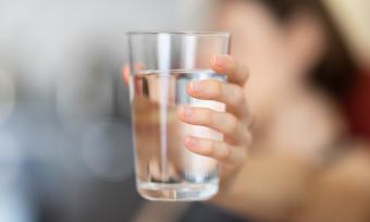 Woman holding water glass