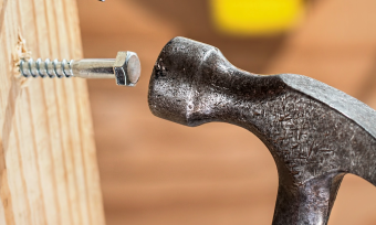 Hammer hitting a screw to symbolise using the wrong tool