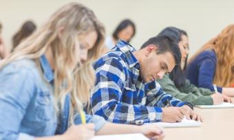 A few students studying carefully in a classroom.