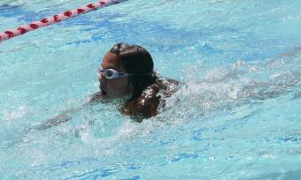 Photo of a young girl swimming wearign goggles.
