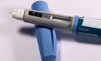 A Syringe of Semaglutide resting on a cap. 