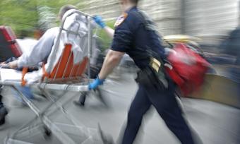 Emergency medical experts bring a trauma patient to a hospital.