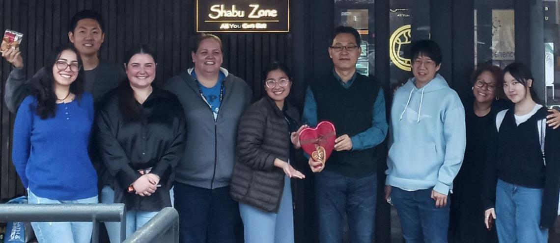 Group of people standing in front of a restaurant