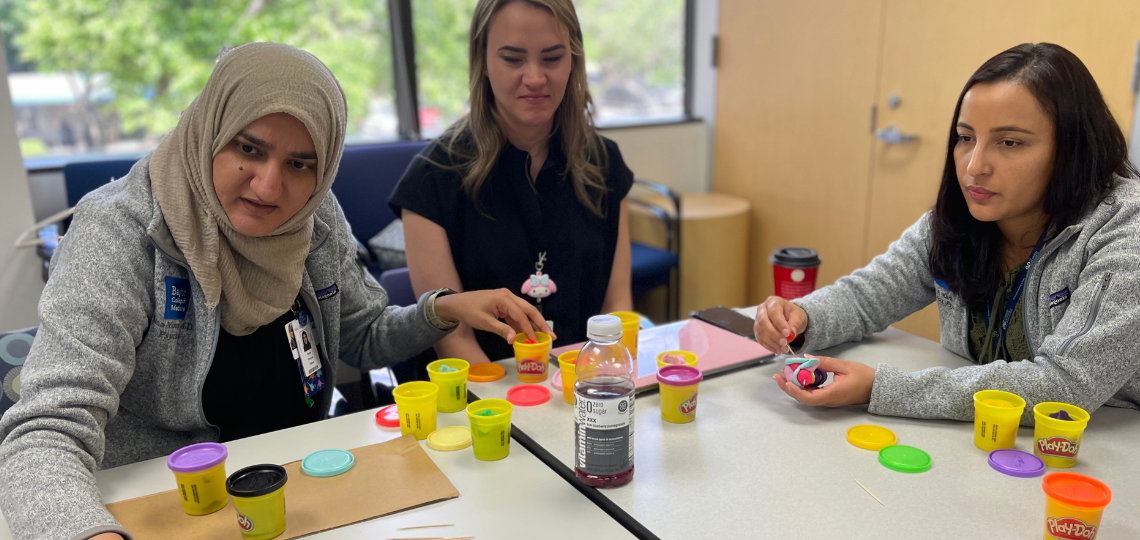 group of fellowship students working with playdoh