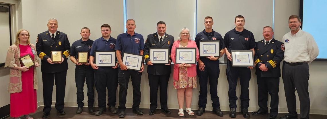 a group of people holding awards and smiling