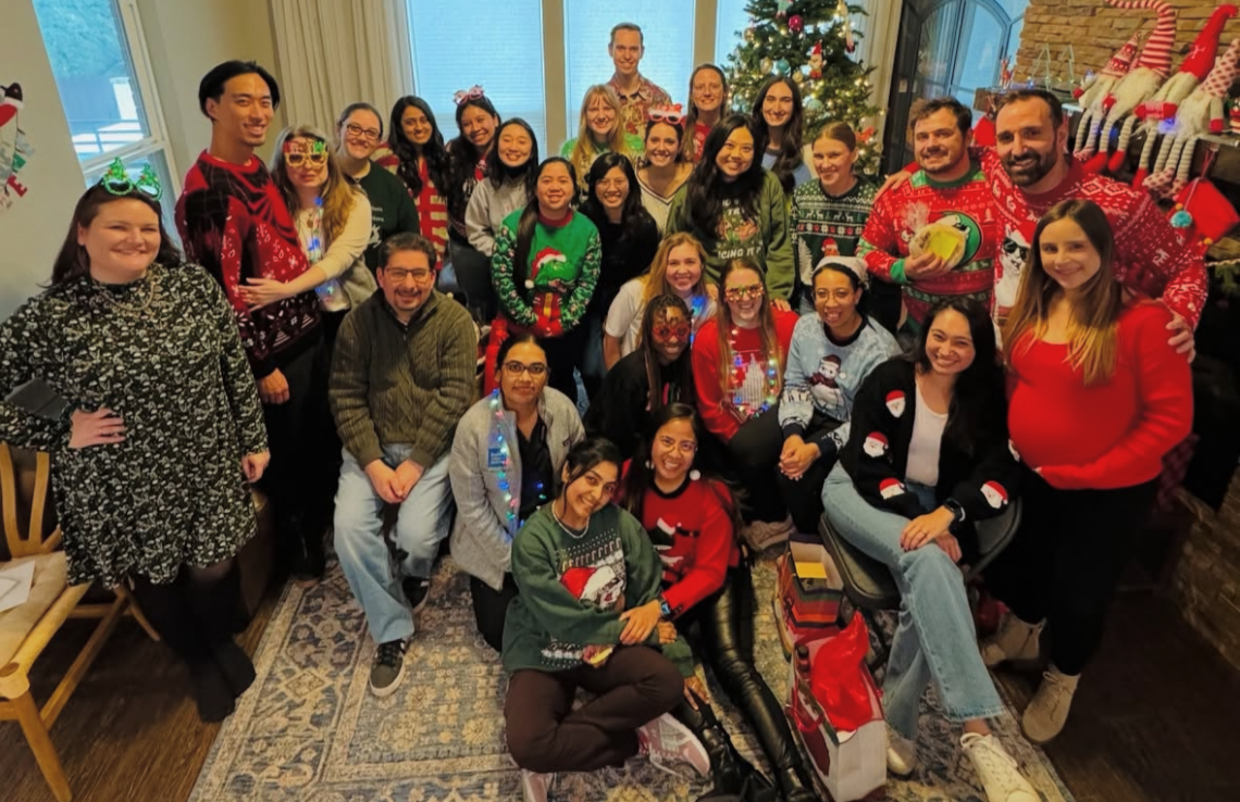 group of people wearing christmass sweaters, smiling