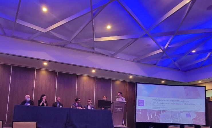 a speaker welcomes attendees to the Annual GI and Liver Course