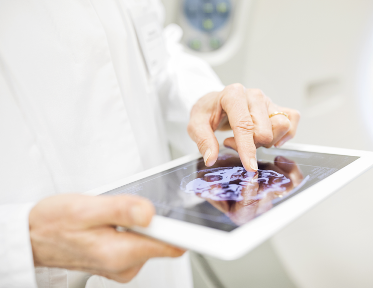 Photo of person holding an electronic tablet