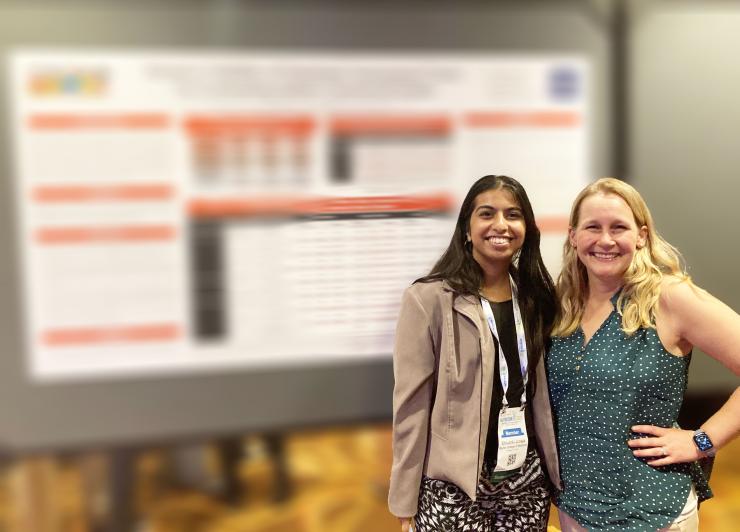 Photo of Shivanki Juneja and Nancy Moran in front of a poster board