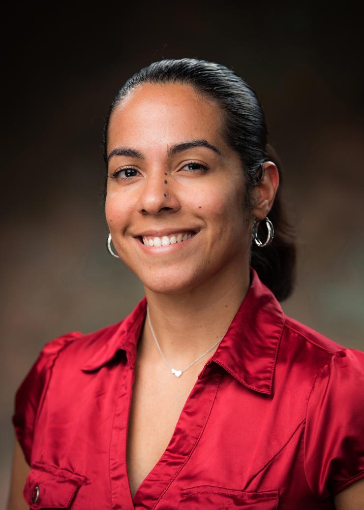 woman in red satin shirt smiling