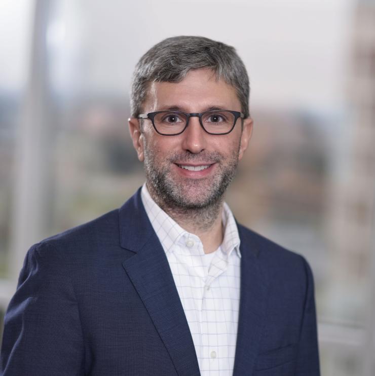 Woman smiling in front of grey background