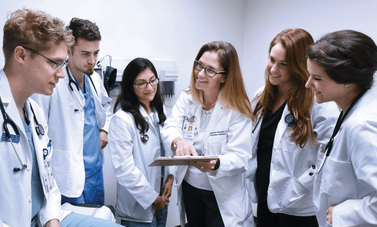 Students and a professor in white coats