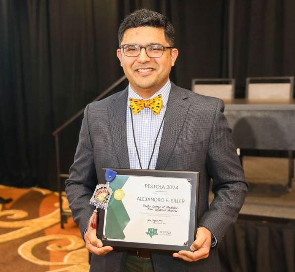 man standing with award plaque