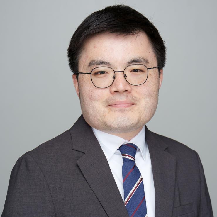 man smiling in front of grey background