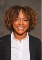 Woman smiling in front of grey background