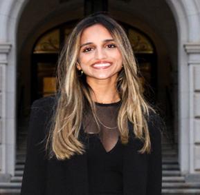 Woman smiling in front of grey background